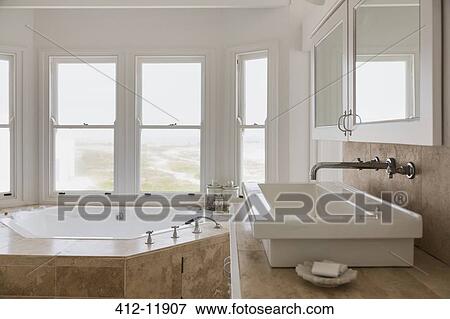 Sink and jacuzzi tub in luxury master bathroom View Large Photo Image Stock Photo - Sink and jacuzzi tub in luxury master bathroom. Fotosearch