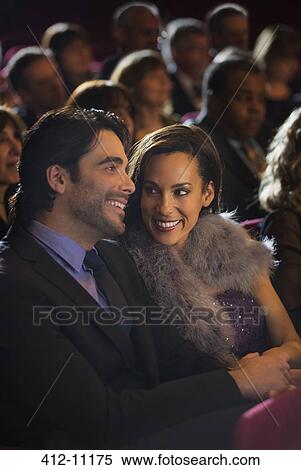 Smiling couple in theater audience View Large Photo Image Stock Photography - Smiling couple in theater audience. Fotosearch