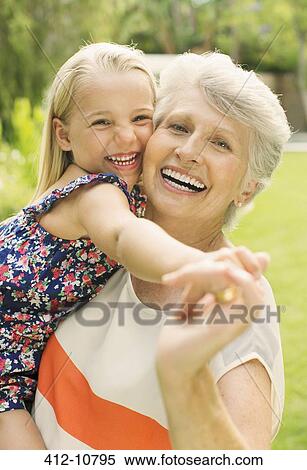Smiling grandmother holding granddaughter View Large Photo Image Stock Photography - Smiling grandmother holding granddaughter. Fotosearch