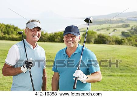 Stock Photo - Smiling senior men on golf course. Fotosearch