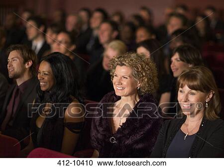 Stock Image - Smiling theater audience. Fotosearch