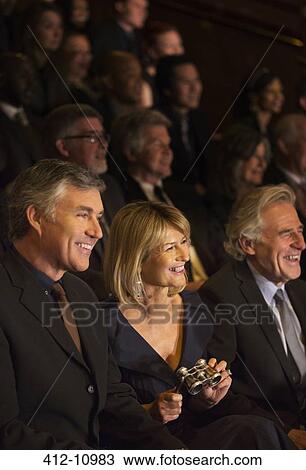 Smiling woman holding opera glasses in theater audience View Large Photo Image Stock Image - Smiling woman holding opera glasses in theater audience. Fotosearch