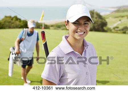 Smiling woman on golf course View Large Photo Image Stock Image - Smiling woman on golf course. Fotosearch