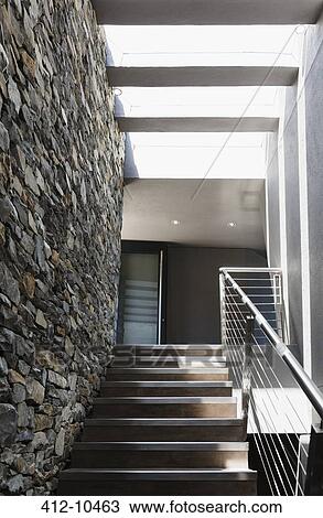 Stairs and stone wall in modern house View Large Photo Image Stock Image - Stairs and stone wall in modern house. Fotosearch