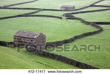 Stone houses and walls in green fields View Large Photo Image Stock Image - Stone houses and walls in green fields. Fotosearch
