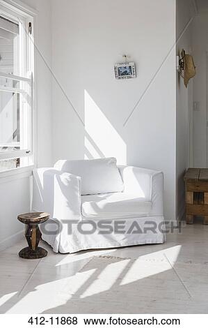 Sun shining on white armchair in corner View Large Photo Image Stock Photo - Sun shining on white armchair in corner. Fotosearch