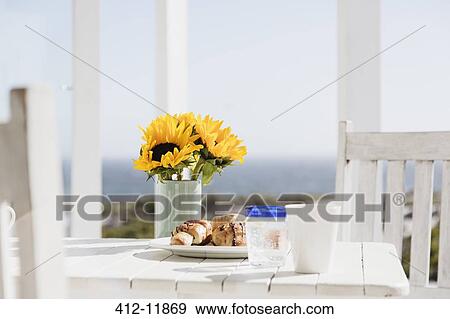 Sunflowers and croissants on patio table View Large Photo Image Stock Photo - Sunflowers and croissants on patio table. Fotosearch