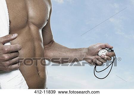 Swimmer holding stopwatch outdoors View Large Photo Image Stock Photo - Swimmer holding stopwatch outdoors. Fotosearch