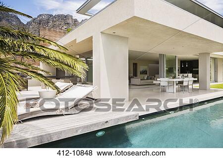 Stock Photo - Swimming pool and patio of modern house. Fotosearch