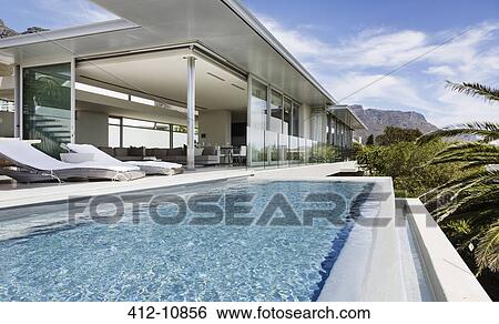 Swimming pool and patio of modern house View Large Photo Image Stock Photograph - Swimming pool and patio of modern house. Fotosearch