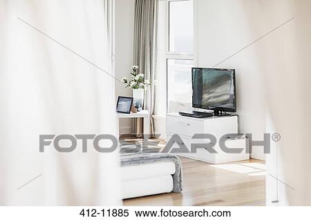 Stock Photography - Television and sofa in sunny living room. Fotosearch
