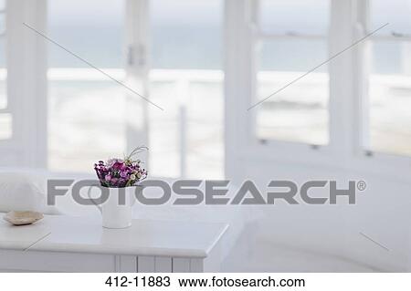 Vase of flowers on desk in bedroom overlooking ocean View Large Photo Image Stock Image - Vase of flowers on desk in bedroom overlooking ocean. Fotosearch