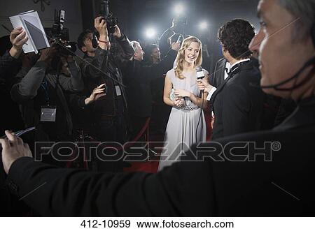 View over bodyguard's shoulder of celebrity being interviewed on red carpet View Large Photo Image Stock Photo - View over bodyguard's shoulder of celebrity being interviewed on red carpet. Fotosearch