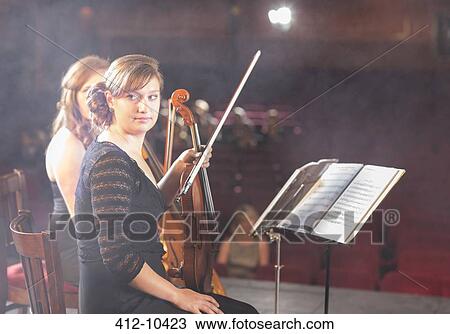 Violinists preparing for performance on theater stage View Large Photo Image Stock Image - Violinists preparing for performance on theater stage. Fotosearch