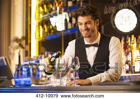 Well dressed bartender pouring wine View Large Photo Image Stock Photo - Well dressed bartender pouring wine. Fotosearch