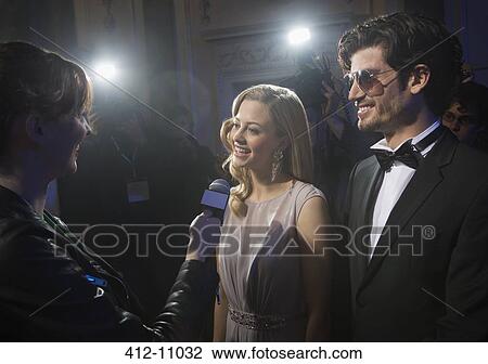 Well dressed celebrity couple being interviewed at red carpet event View Large Photo Image Stock Image - Well dressed celebrity couple being interviewed at red carpet event. Fotosearch