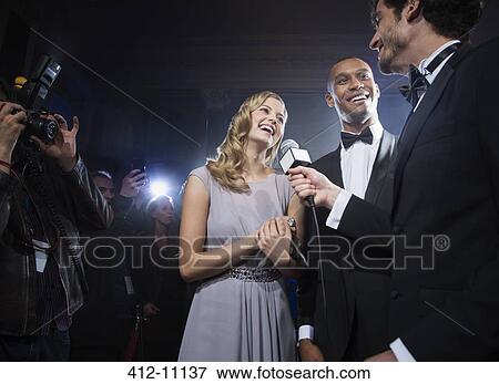 Well dressed celebrity couple being interviewed at red carpet event View Large Photo Image Stock Photo - Well dressed celebrity couple being interviewed at red carpet event. Fotosearch