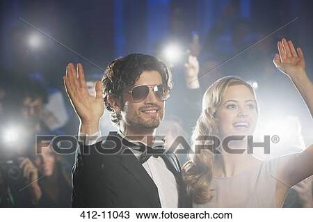 Well dressed celebrity couple waving to paparazzi View Large Photo Image Stock Image - Well dressed celebrity couple waving to paparazzi. Fotosearch