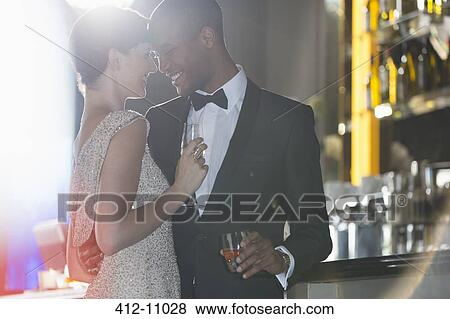 Well dressed couple hugging in luxury bar View Large Photo Image Stock Photo - Well dressed couple hugging in luxury bar. Fotosearch