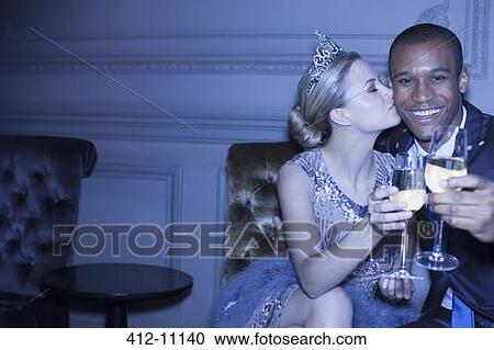 Well dressed couple kissing and toasting champagne flutes View Large Photo Image Stock Image - Well dressed couple kissing and toasting champagne flutes. Fotosearch