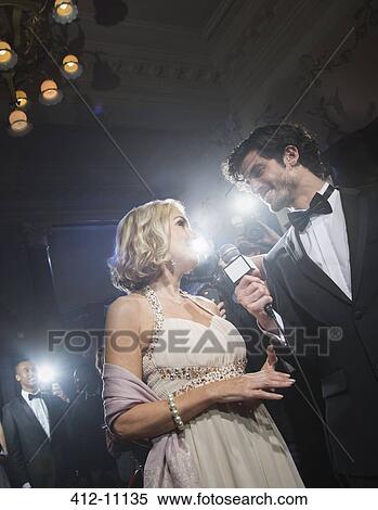 Well dressed female celebrity being interviewed at red carpet event View Large Photo Image Stock Photography - Well dressed female celebrity being interviewed at red carpet event. Fotosearch