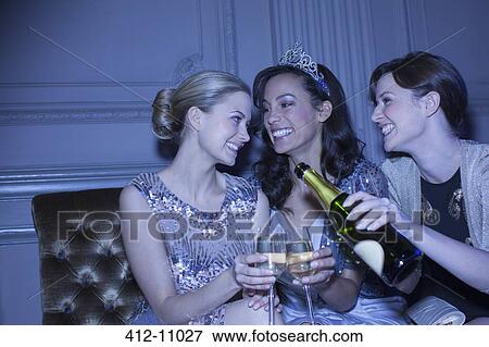 Well dressed women drinking champagne in luxury nightclub View Large Photo Image Stock Photo - Well dressed women drinking champagne in luxury nightclub. Fotosearch