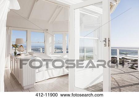 White bedroom overlooking ocean View Large Photo Image Stock Image - White bedroom overlooking ocean. Fotosearch