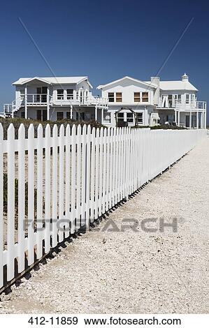White picket fence leading to beach houses View Large Photo Image Stock Photo - White picket fence leading to beach houses. Fotosearch