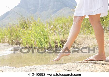 Woman dipping toe in rural pond View Large Photo Image Stock Image - Woman dipping toe in rural pond. Fotosearch