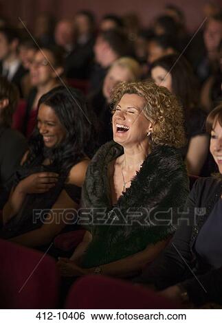 Woman laughing enthusiastically in theater audience View Large Photo Image Stock Photograph - Woman laughing enthusiastically in theater audience. Fotosearch