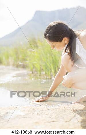 Woman playing in rural lake View Large Photo Image Stock Photo - Woman playing in rural lake. Fotosearch