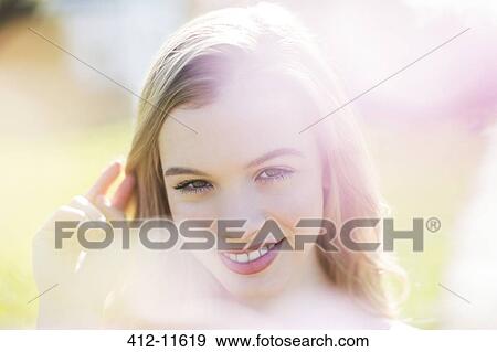 Stock Photo - Woman smiling outdoors. Fotosearch