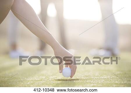 Woman teeing golf ball on course View Large Photo Image Stock Photo - Woman teeing golf ball on course. Fotosearch