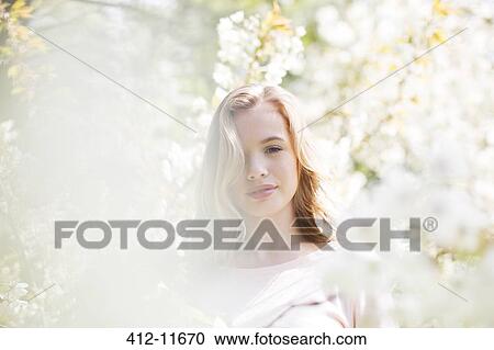 Woman under tree with white blossoms View Large Photo Image Stock Image - Woman under tree with white blossoms. Fotosearch
