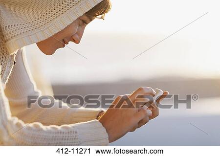Woman using cell phone outside View Large Photo Image Stock Image - Woman using cell phone outside. Fotosearch