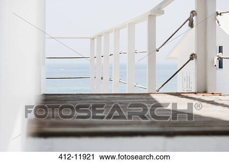 Wooden balcony overlooking ocean View Large Photo Image Stock Image - Wooden balcony overlooking ocean. Fotosearch