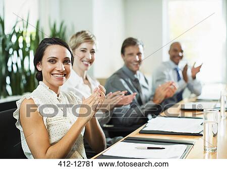 Stock Image - Business people clapping in meeting. Fotosearch