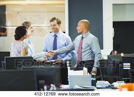 Business people shaking hands in office View Large Photo Image Stock Photo - Business people shaking hands in office. Fotosearch