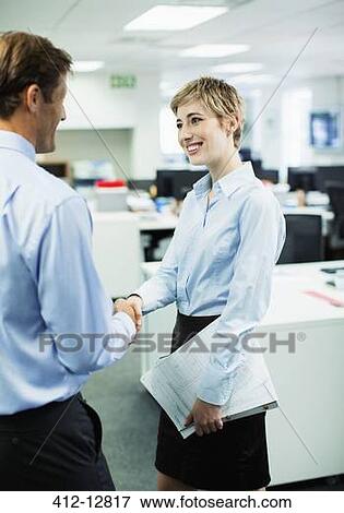 Stock Photo - Business people shaking hands in office. Fotosearch