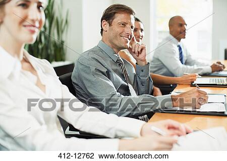 Business people sitting in meeting View Large Photo Image Stock Image - Business people sitting in meeting. Fotosearch