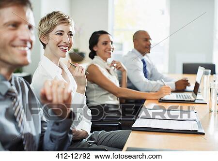 Stock Image - Business people sitting in meeting. Fotosearch