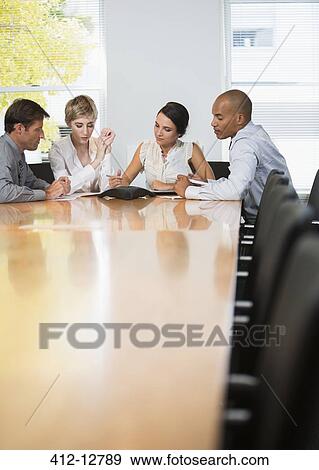 Business people sitting in teleconference View Large Photo Image Stock Photo - Business people sitting in teleconference. Fotosearch