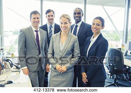 Business people smiling in office View Large Photo Image Stock Photo - Business people smiling in office. Fotosearch