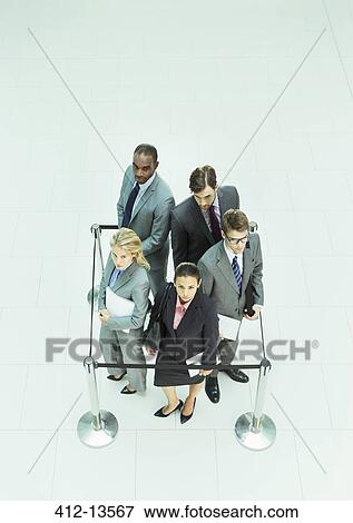 Business people standing in roped-off square View Large Photo Image Stock Photo - Business people standing in roped-off square. Fotosearch