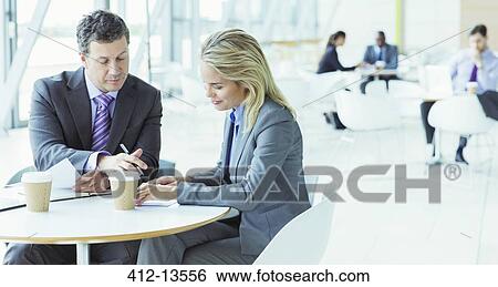 Stock Photograph - Business people talking in cafe. Fotosearch