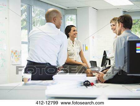 Business people talking in office View Large Photo Image Stock Photo - Business people talking in office. Fotosearch