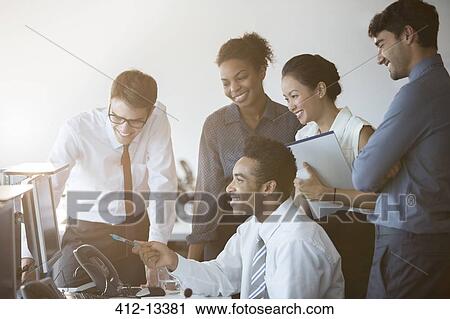 Stock Image - Business people working at computer in office. Fotosearch