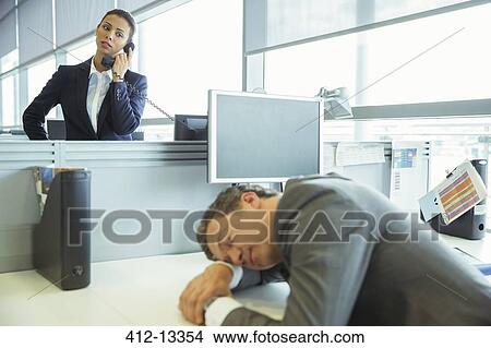 Businessman sleeping at desk in office View Large Photo Image Picture - Businessman sleeping at desk in office. Fotosearch