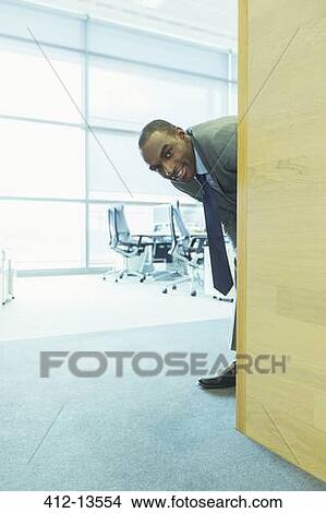 Picture - Businessman smiling in office. Fotosearch