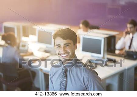 Businessman smiling in office View Large Photo Image Stock Photograph - Businessman smiling in office. Fotosearch
